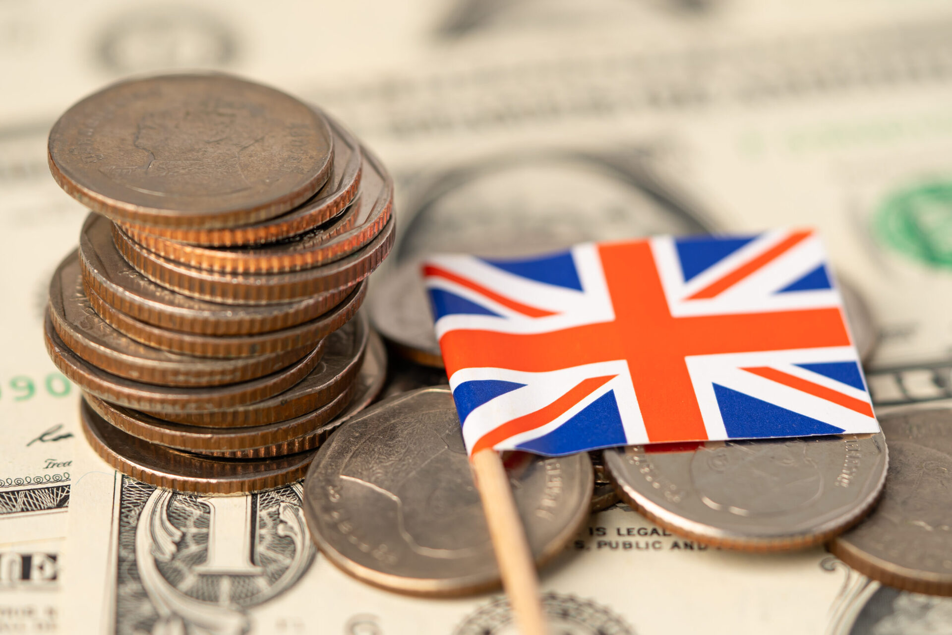 United Kingdom Flag on coins background , Business and finance c