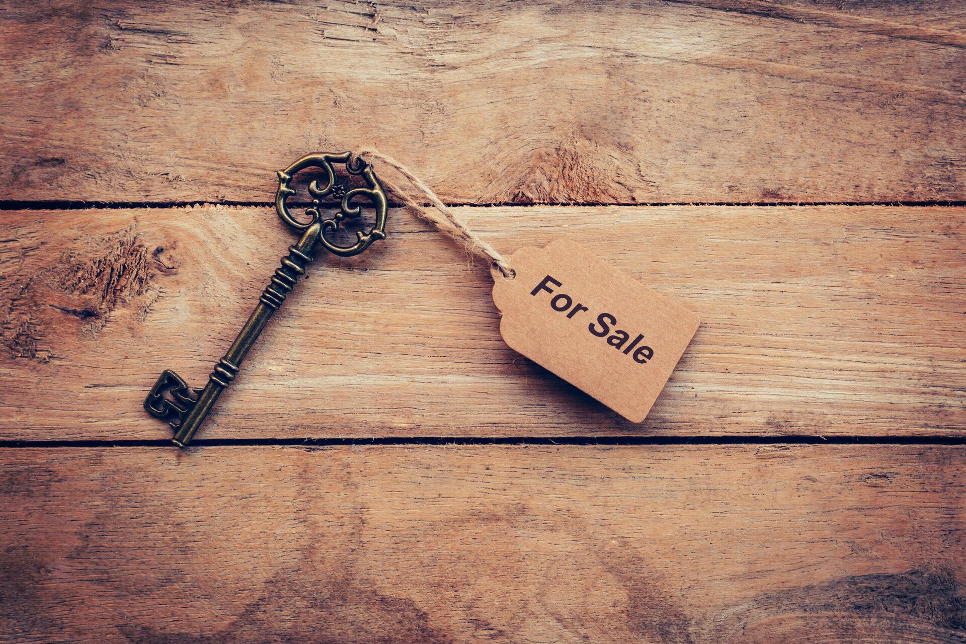 Business concept – Old key vintage on wood with tag For Sale.
